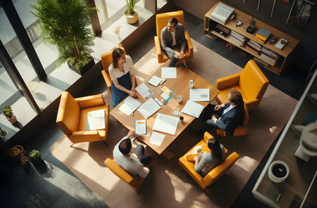 Top view of business people sitting at table and working together in officeの素材