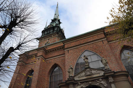 Church at the backside in stockholm sweden on a cloudy fall day, with some Latin text at the entrance. Translation Latin text: The word of the Lord remains eternal.の写真素材