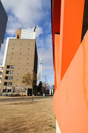 Rotterdam, Netherlands, 11-09-2019: Peek thourgh of the Erasmus bridge through the buildings and streets at the head of south in Rotterdam, with a blue skyのeditorial素材
