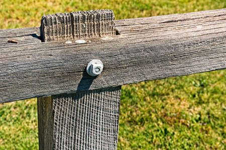 A closeup of an old fence post and railing at the Bodie Ghost Town State Park in Californiaの写真素材
