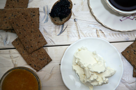 Cottage cheese with black caviar on a white plate on a wooden tableの写真素材