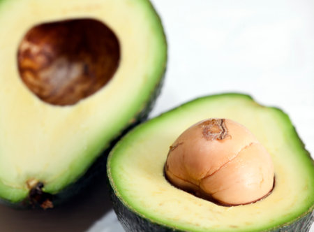 Avocado cut in half on a white background, close-up