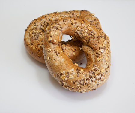 Two bagels with sesame seeds on a white background. Close-up.