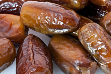 Close up of dried dates fruits on white background. Selective focus.の写真素材