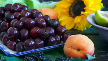 Cherriescots and blackberries on a wooden table