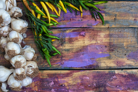 Fresh garlic and chilli on a wooden background. Top view.の写真素材