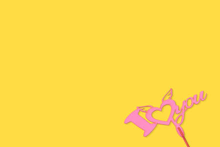 Pink love sign isolated on beautiful yellow backgroundの写真素材