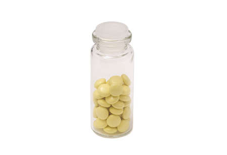 Glass bottle of pills tablets isolated on whiteの写真素材
