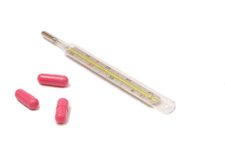Glass thermometer with three magenta pills isolated on whiteの写真素材
