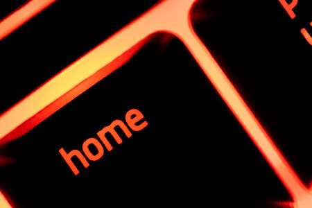 Red illuminated keyboard home key closeup