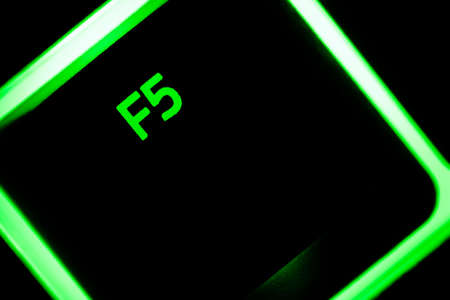 Green illuminated keyboard F5 key closeup