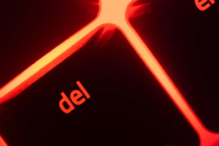Hazy red illuminated keyboard delete key closeupの写真素材
