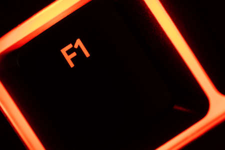 Red illuminated keyboard F1 key closeupの写真素材