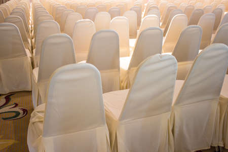 Chairs covered with white cloth, usually used for weddingsの写真素材