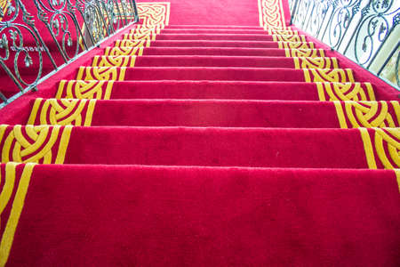 The ladder is covered by a red carpet の写真素材