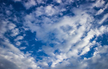 Sky background with the fluffy white clouds