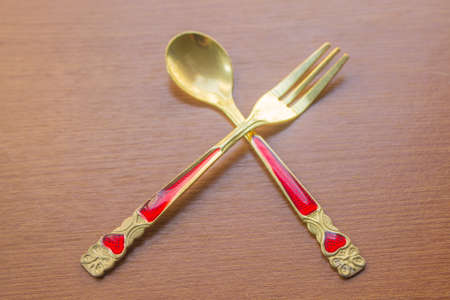 spoon and fork on wooden table background