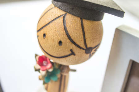 Wooden Dolls, and picture frame with a white background.の写真素材