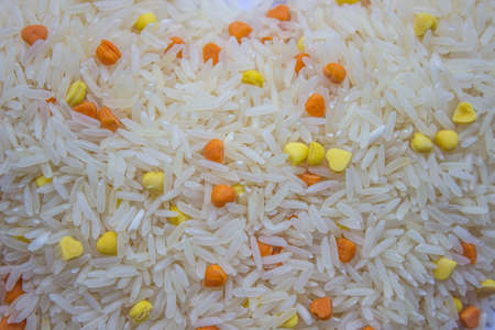 Raw rice with colors on a white background.の写真素材