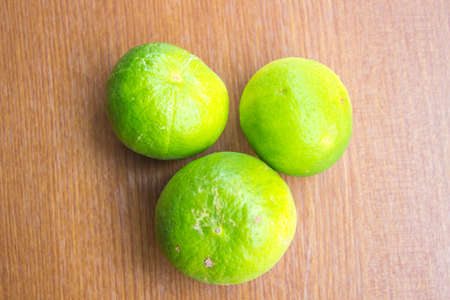 Fresh lemon three balls on a wooden background.