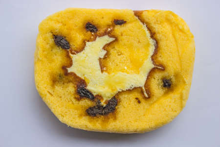 Slide the cake with raisins on white background.