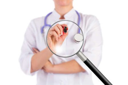 The doctor is holding the red marker, ready to write, isolated background, magnifying glassの写真素材