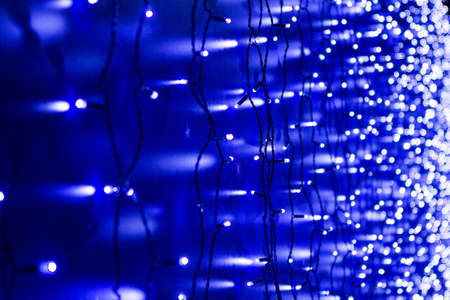 Christmas lights frame on dark blue background with copy spaceの写真素材