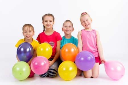 Four joyful child sitting with beadsの写真素材