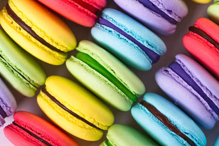 collection of colorful French macarons are next to each other on a white background