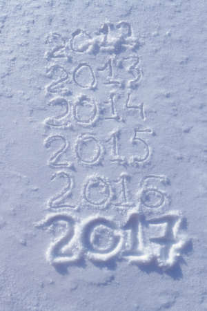 new years date 2017 written in fresh powder snow, Christmas backgroundの写真素材