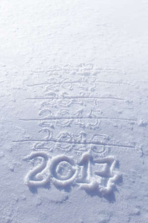 new years date 2017 written in fresh powder snow, Christmas backgroundの写真素材