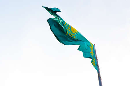 The Kazakhstan flag on the background of blue sky in the daytimeの写真素材