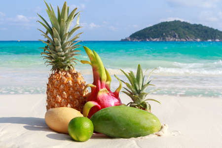 Exotic tropical fruits on the sandy beachの写真素材