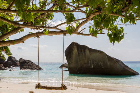 White sand beach wooden swing tranquil relax beautiful sea. Thailand Similan Islands.の写真素材