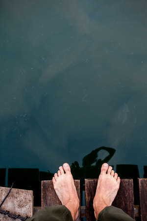 bare feet on the edge of the Board, bottom waterの写真素材