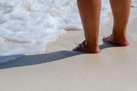 woman legs, walking on the beach