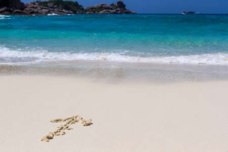 drawing arrow on sandの写真素材