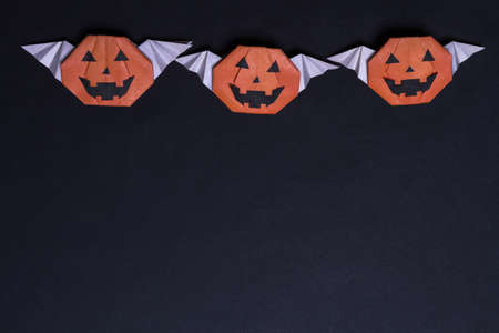 Black Halloween. On a black background made from paper pumpkinの写真素材