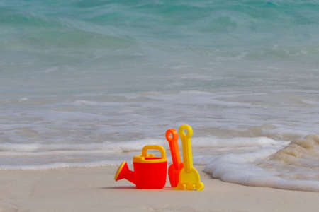 Children's beach toys - buckets, spade and shovel on sand on sunny dayの写真素材