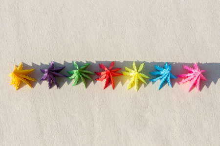 Seven paper Christmas trees stand in the sand against the blue sea. Similan Islands