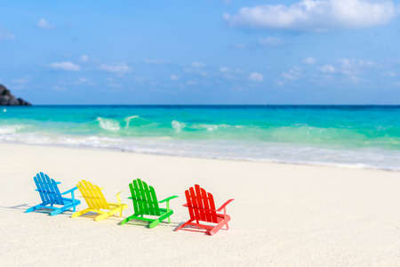 Beach chairs on the sandy beaches for tourists to sit and relax in the soft ocean waves breaking on the beach. Made of paper.の写真素材