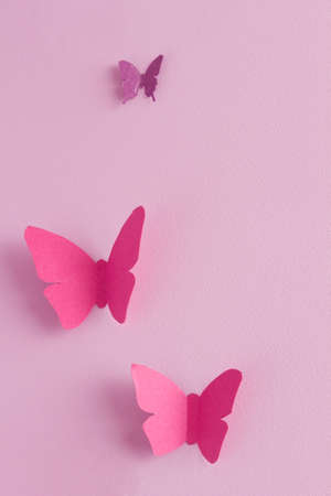 Paper butterflies on a pink background. Love and Valentine's day concept. Top viewの写真素材