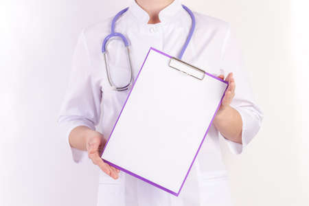 Doctor in white robe with stethoscope, with folder in hand, on white isolated backgroundの写真素材