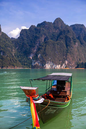 Tropical Thai jungle lake Cheo lan wood boat, wild mountains nature national park ship yacht rocks