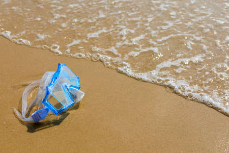 The swimming mask on the sandy beach. Scuba diving.