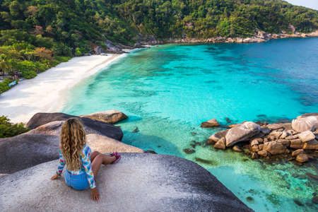 Young female stand on viewpoint sailing rock in Similan island. Freedom traveler woman enjoy a wonderful nature on Similan No.8 at Similan national park, Phuket, Thailand. Travel conceptの写真素材