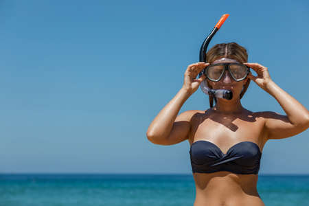 Young beautiful girl in a mask for divingの写真素材