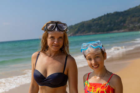 Young girl with a girl in masks for snorkeling. Happy peopleの写真素材