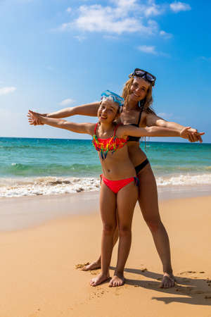 Young girl with a girl in masks for snorkeling. Happy peopleの写真素材