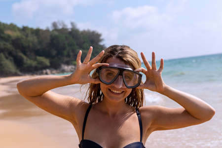 Young girl in a mask for diving. Happy people.の写真素材